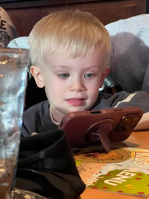 Captivated by the screen.